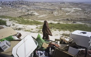 A member of the Ghaith family looks on at the rubble of the family home