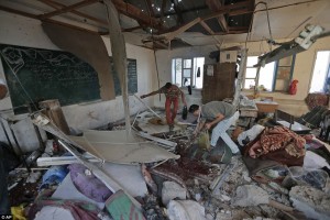 Palestinians collect body parts in a classroom at the Abu Hussein UN school. Click to enlarge