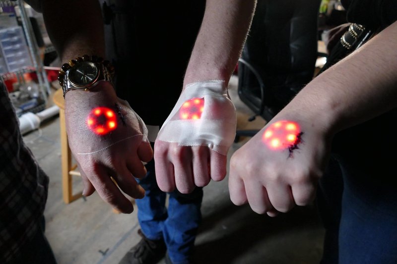 Justin Worst, Marlo Webber and Jes Waldrip show off an LED light implant. Grindhouse Wetware calls it the Northstar.