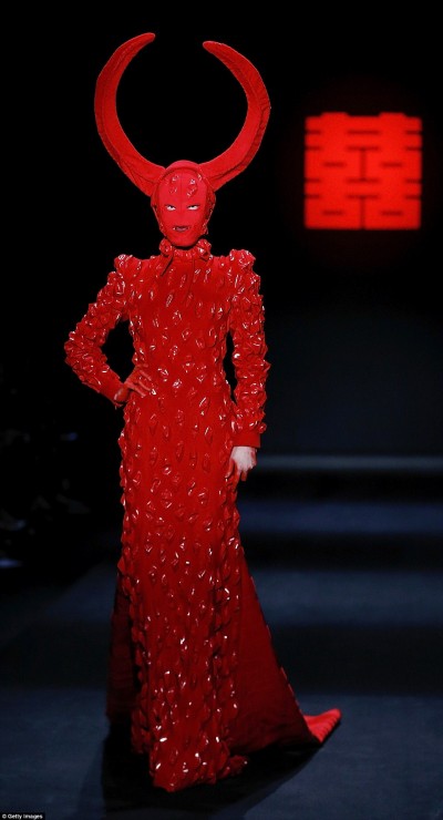 The fashion show by Chinese designer Designer Hu Sheguang was all about blood sacrifice, satanism and mind control imagery. In short, it was an unfiltered representation of the occult elite’s true face. In this pic, a masked model walking around with gigantic devil horns on her head. Click to enlarge