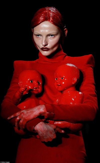 This model holds two dolls covered in fake blood. A sickening way of representing child sacrifice.