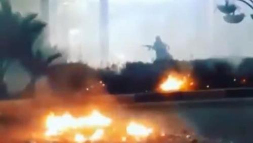 A still from a video of a protester in Khorramshahr on Saturday carrying what looks like an assault rifle. Click to enlarge