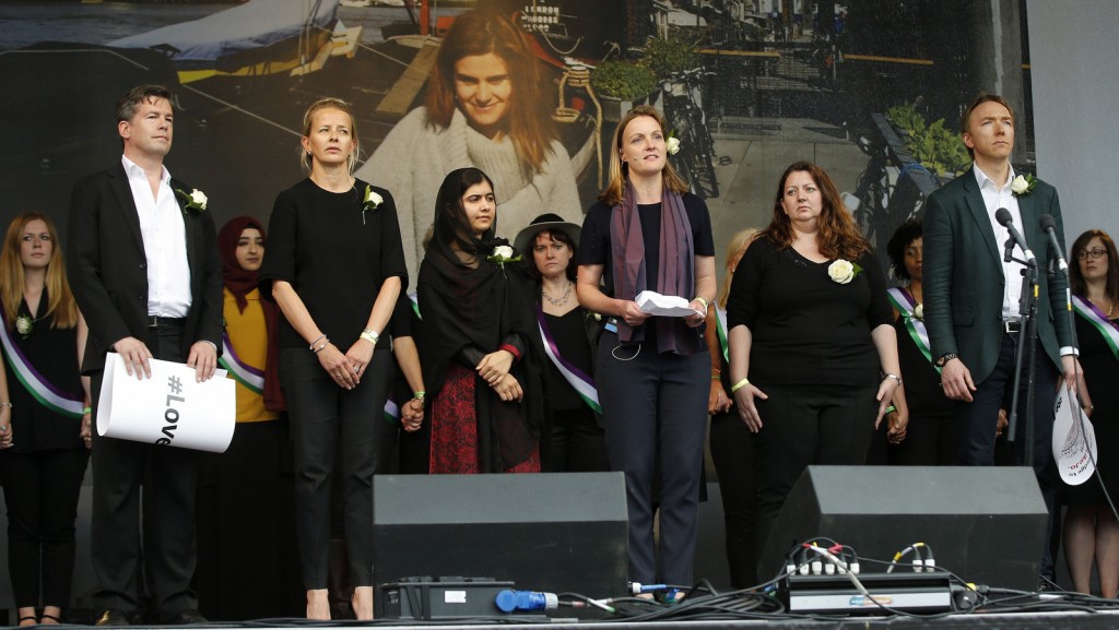 Nick Grono, left, Mabel van Oranje, second left, and Tim Dixon, right stand on stage with others at a a Jox Cox commemoration at Trafalgar Square in London. Alastair Grant | AP
