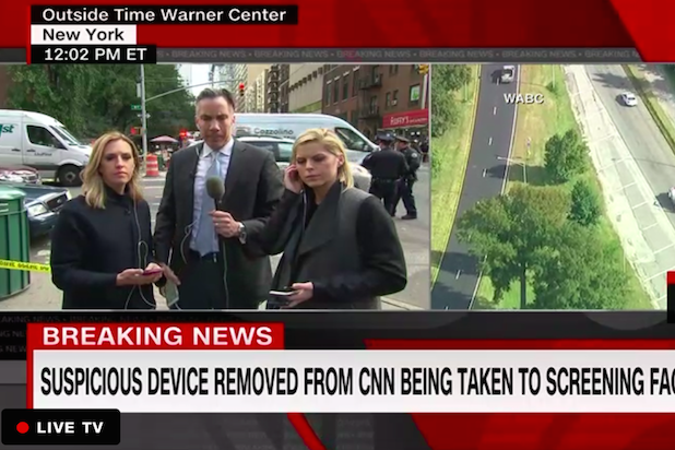 News hosts continue to broadcast outside CNN's New York headquarters after the building was evacuated following the discovery of a suspected pipe bomb. Click to enlarge