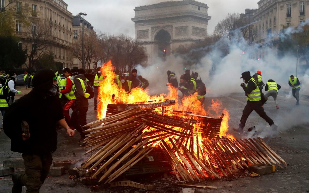 Demonstrators during a protest of “yellow vests” against rising oil prices and living costs, near the Champs Elysees in Paris, France, on December 1, 2018. Click to enlarge