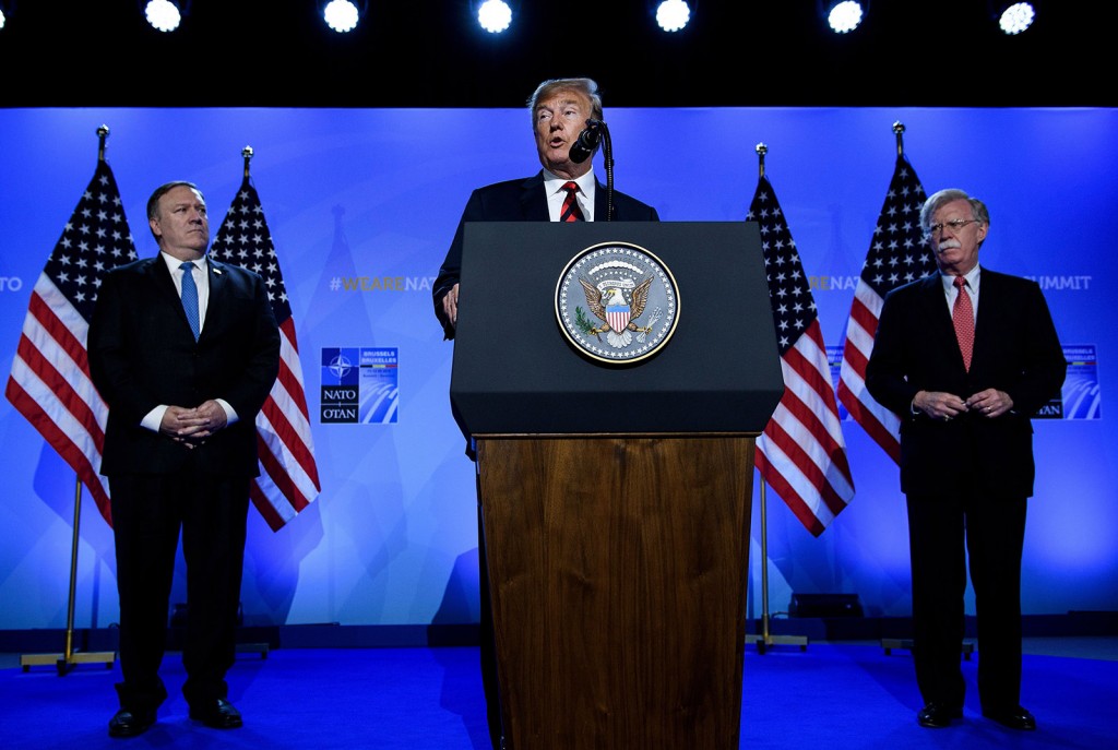 US President Donald Trump (C) is accompanied by US Secretary of State Mike Pompeo (L) and US National Security Advisor John Bolton (R) as he addresses a press conference on the second day of the North Atlantic Treaty Organization (NATO) summit in Brussels on July 12, 2018. (Photo by Brendan Smialowski / AFP) (Photo credit should read BRENDAN SMIALOWSKI/AFP/Getty Images)