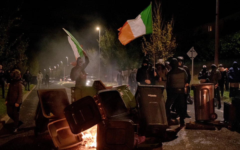Rioters attack Irish police outside migrant hotel
