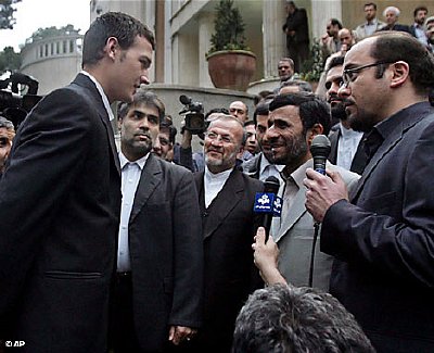 President Ahmadinejad meets with the Britons before a throng of reporters.