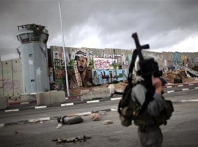 The Israeli Wall of Apartheid at Kalandia checkpoint on March 16 - How can Americans support such a blatantly racist regime in Israel? Why is Jewish racism tolerated?