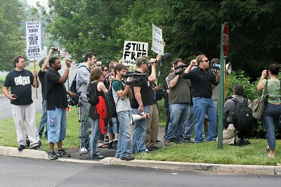 Despite minimal media coverage, a small group of protestors did voice their concerns. Notable among them is Alex Jones, next to the Stop sign on the right.
