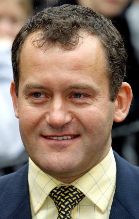 Paul Burrell smiles as he leaves the court after the trial against him collapsed