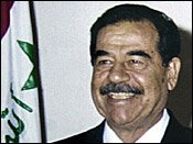 In contrast to the near perfect set of dentures he displays in this 2002 photo. Clear evidence that the man on trial in Baghdad is not the real Saddam Hussein.